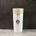 Close-up of stainless steel vacuum insulated coffee flask showing specifications