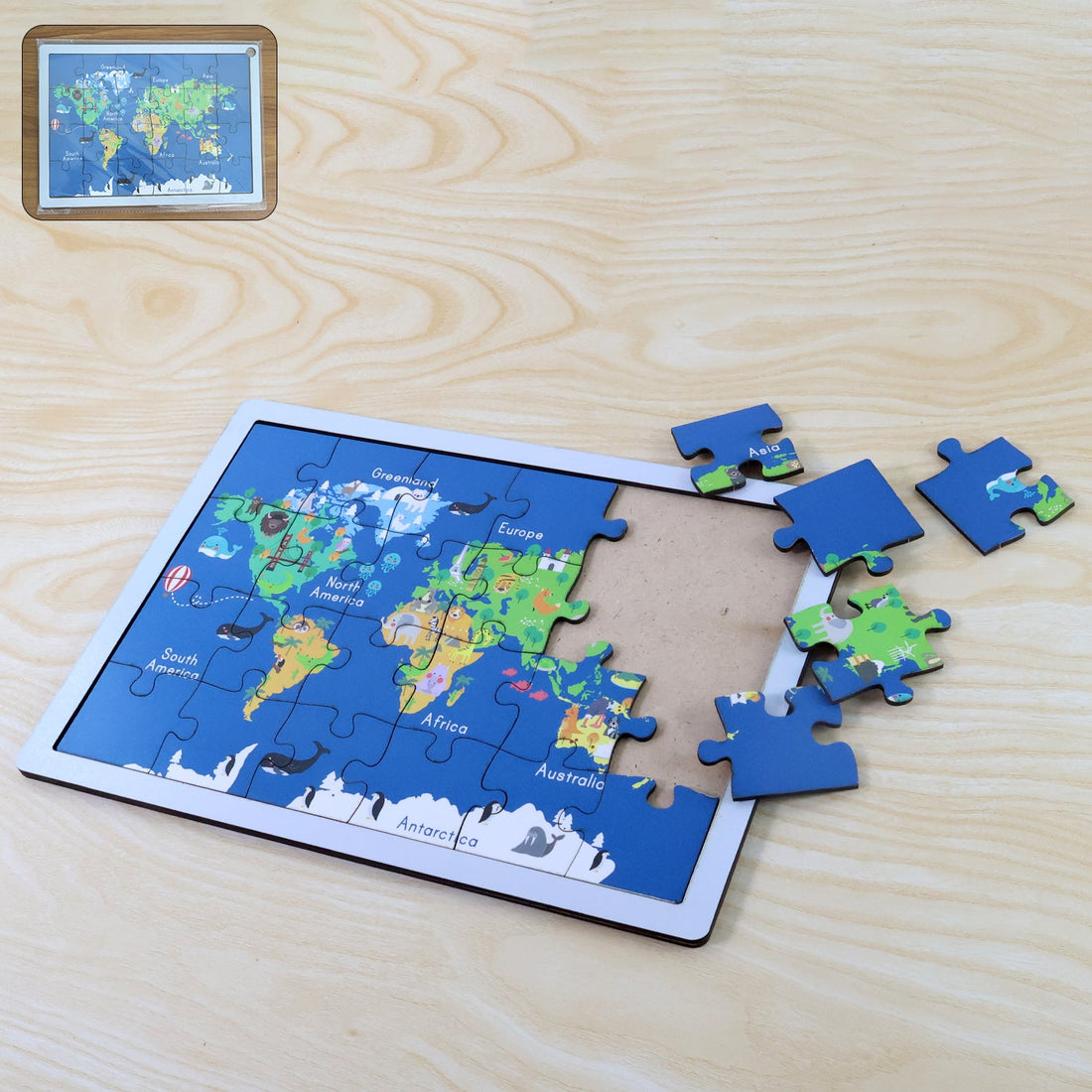 Completed wooden world map puzzle showing continents, animals, and landmarks.