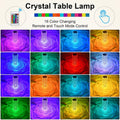 A person touching the top of the Crystal Touch Lamp to change its color.