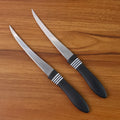 Ergonomic black ABS handle of serrated kitchen knife for comfortable grip