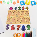 Wooden puzzle board displaying animal-shaped pieces with knobs