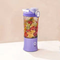 The portable juicer connected to its USB charging cable, highlighting its convenience.
