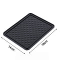The non-slip anti-skid mat demonstrated holding small items firmly in place.
