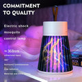 The Mosquito Killer Lamp emits purple light with lightning effects, sitting on a table next to a book.