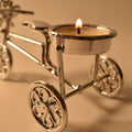Close-up of tealight candle burning on decorative cycle stand holder