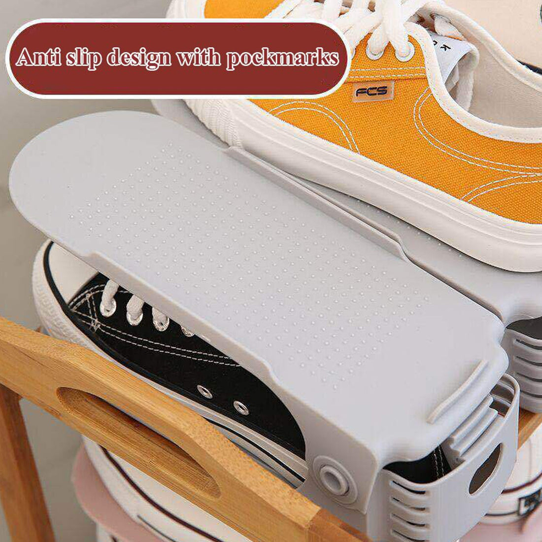 A multi-color adjustable shoe organizer neatly stacking a pair of sneakers.