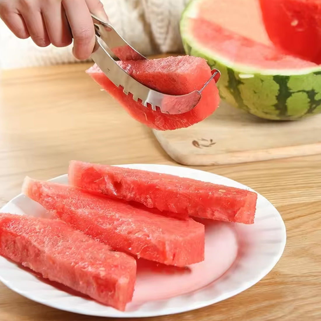 Stainless steel watermelon slicer effortlessly cutting a fresh watermelon.