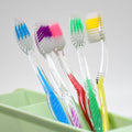 Side view of a MintGuard premium plastic toothbrush, showcasing its sleek design.