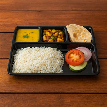 Durable plastic 4-compartment meal tray for portion control and organized dining.