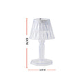 A modern mini crystal table lamp glowing softly in a contemporary interior.