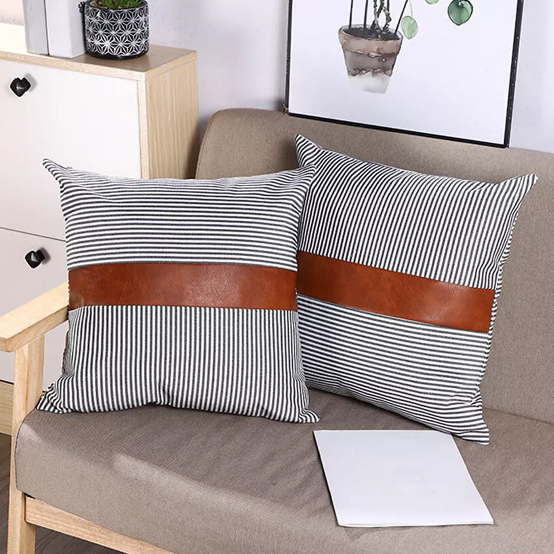 Pair of leather and cotton pillow covers on a modern sofa