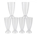 Transparent plastic milkshake glasses neatly arranged on a dining table