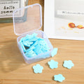 Multiple colourful packs of mini travel soap paper sheets displayed together.