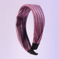 Dark ribbed knot hairband on white background showcasing textured fabric
