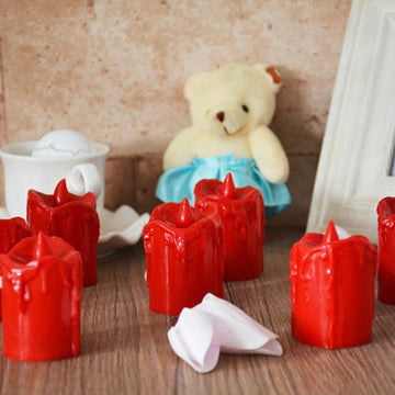 A set of 24 multicolor flameless LED candles with a melted wax design, glowing warmly.