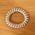 Multiple spiral coil hair bands in assorted shades, offering versatile styling.