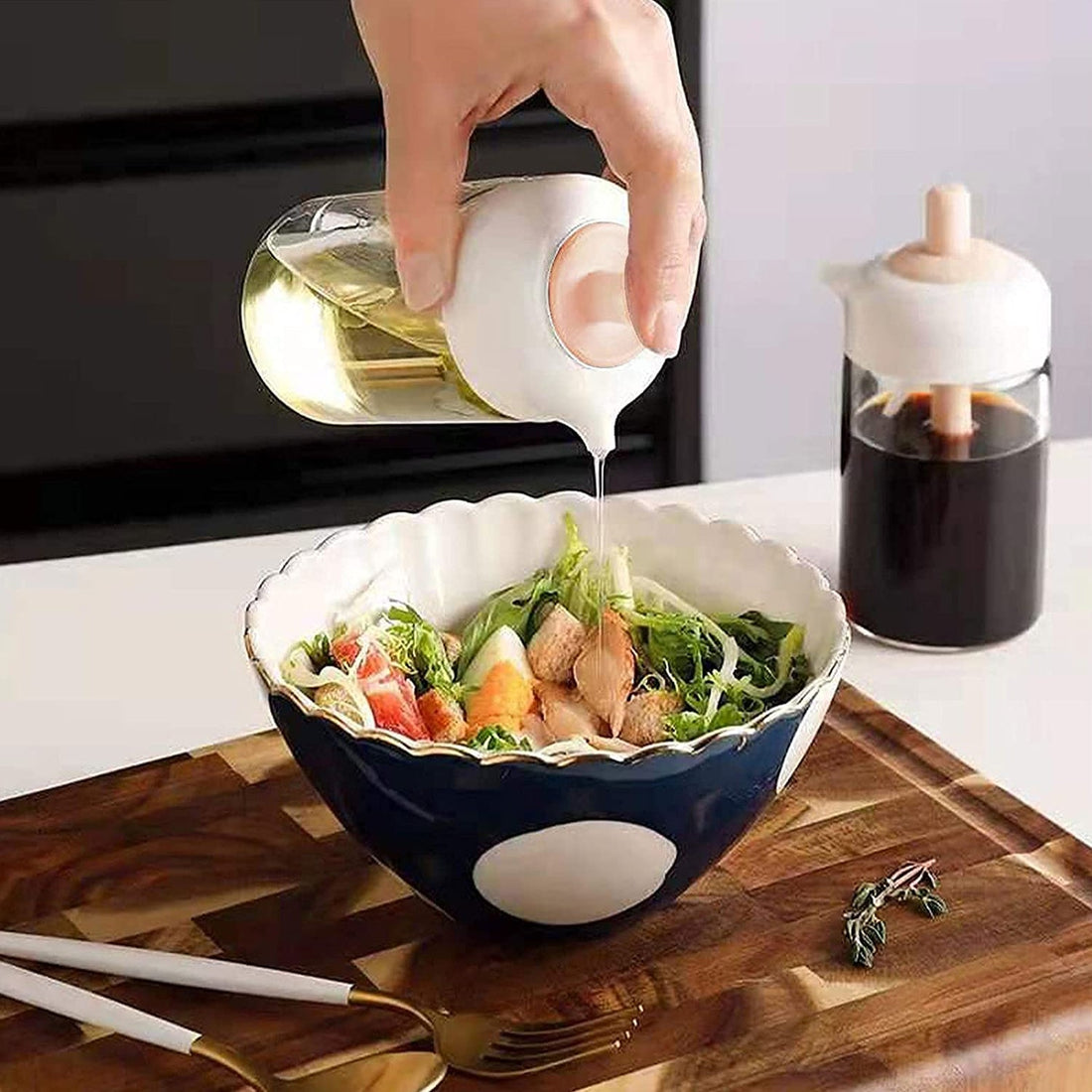 2-in-1 oil dispenser with integrated silicone brush on a kitchen counter.