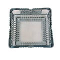 The elegant square glass ashtray displayed in a home or office setting.