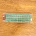 Close-up of high-quality fabric and grid pattern on the green pouch.