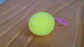 Worm fidget toy in various flexible shapes on white surface