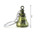 A metal temple bell keychain held in hand, illustrating its compact size and design.