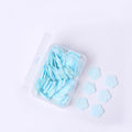 Detailed view of flower-shaped soap sheets beginning to dissolve in water.