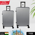 Two hard case trolley bags, big and small, in striking multi-colors, ready for travel.