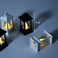 Group of flameless candle lanterns arranged for home decoration.