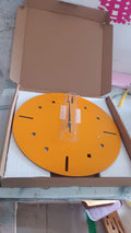 Yellow round wall clock displayed in contemporary room setting