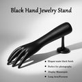 Palm side of black hand-shaped jewelry organizer stand