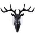 White deer head self-adhesive wall hook attached to a door, ready for use.