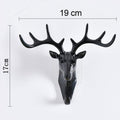 Stylish deer head hook in grey, functioning as a decorative hanger for a hat.