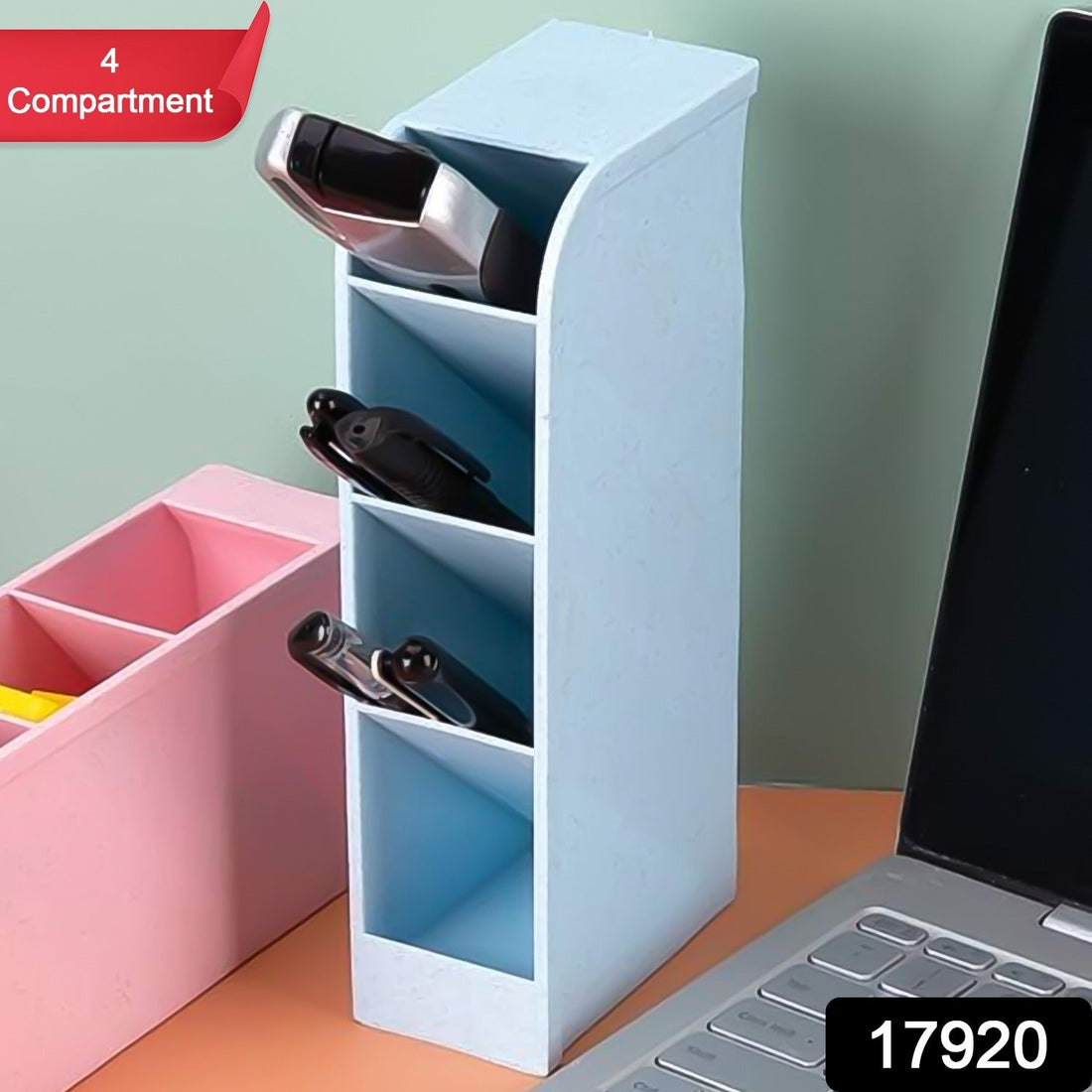 Clear plastic desktop pen holder with four compartments, neatly organising pens and pencils.