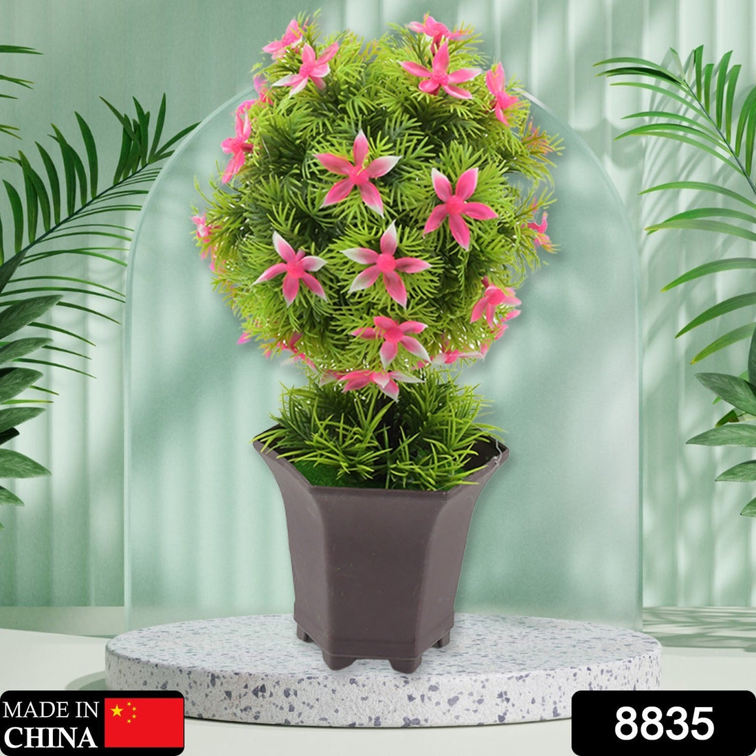 Artificial flower plant with a cute white pot on a wooden surface, enhancing home decor.