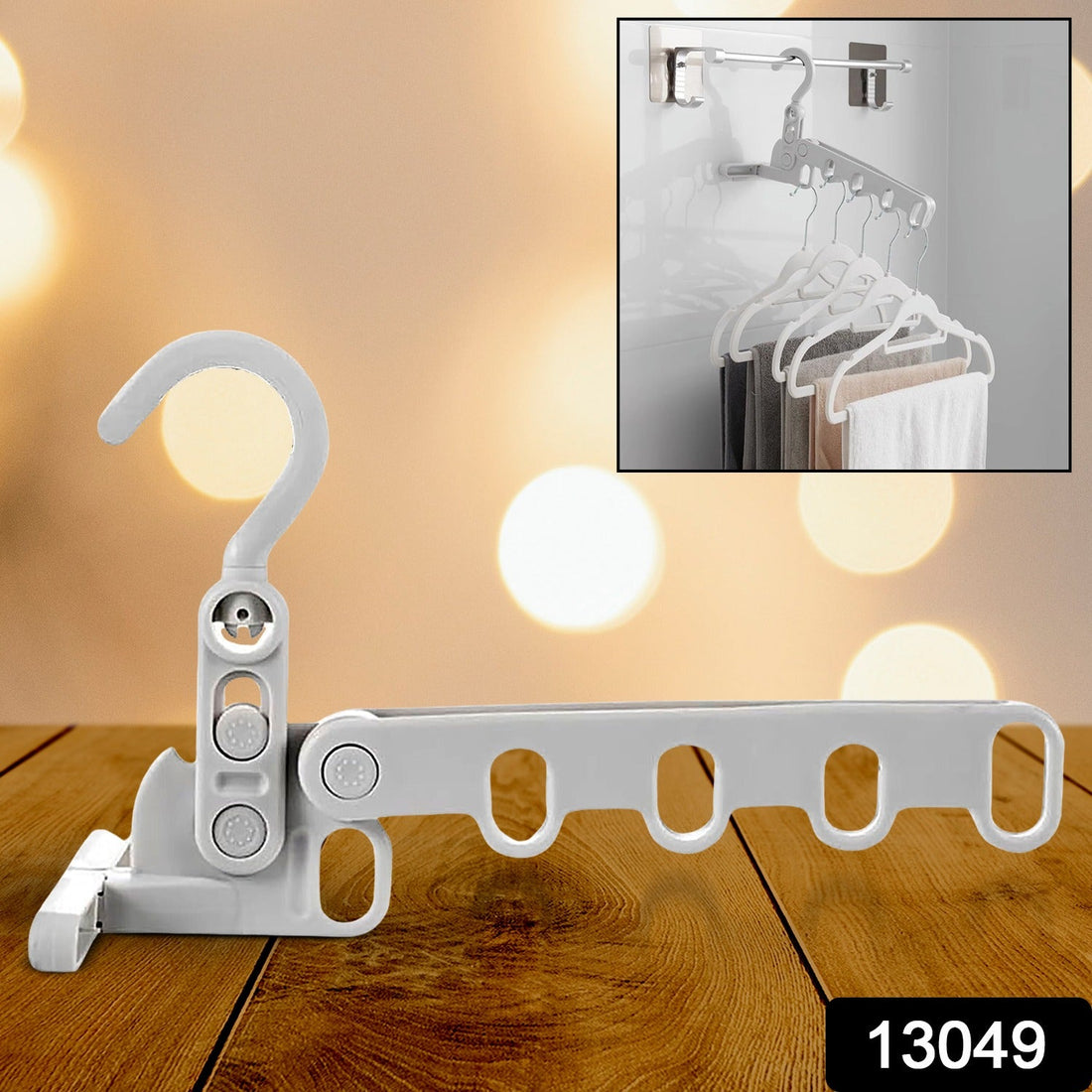Foldable clothes hanger with 5 holes, shown extended for use in a closet.