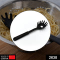 Close-up of a black heat-resistant pasta server with its unique tooth spacing and ergonomic handle.