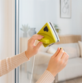 Magnetic window cleaner being used on a modern home window for sparkling glass.