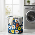 Collapsible canvas laundry bag standing upright, used for toy storage in a modern living room.