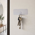 Keys hanging on transparent wall hook for organization