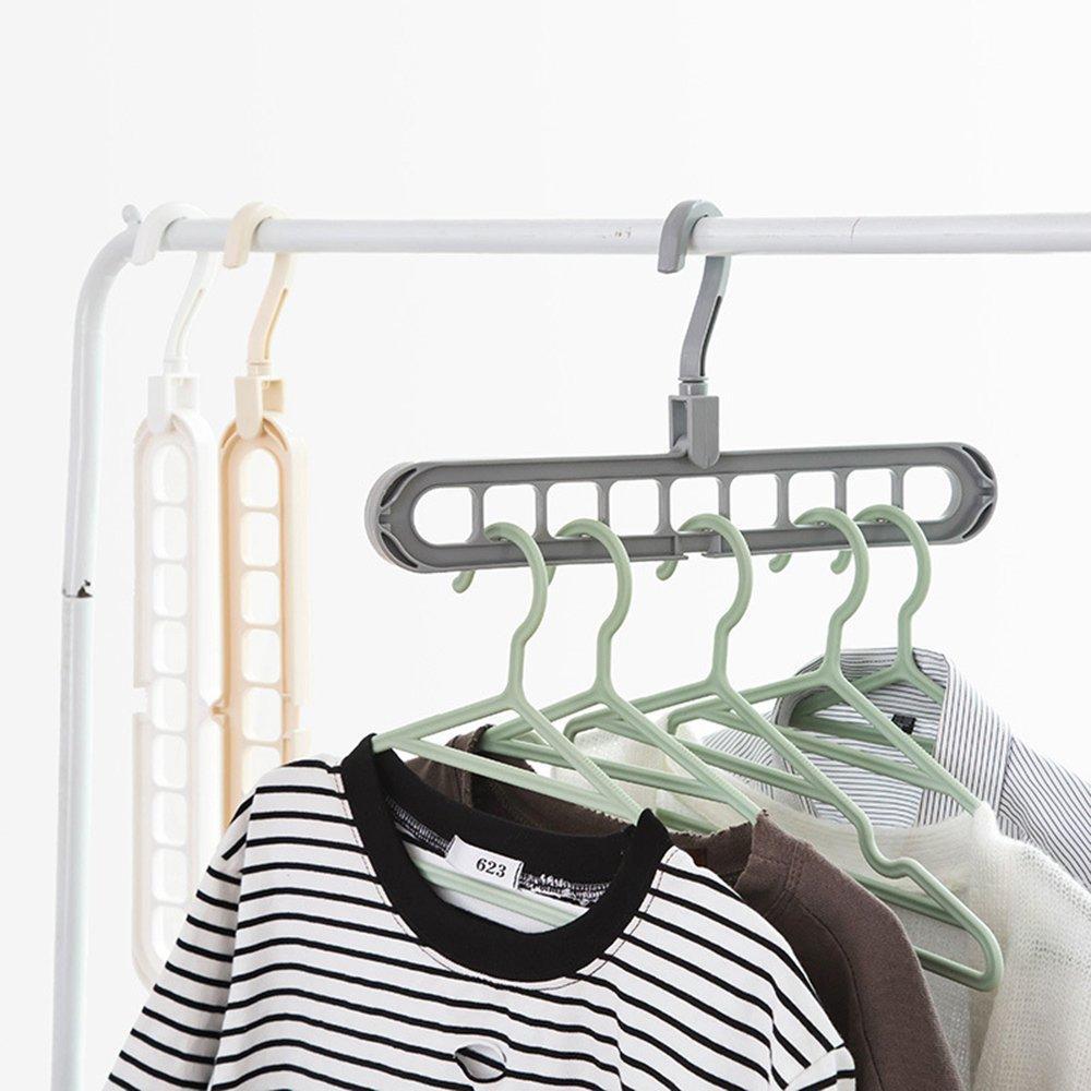 A white space saving hanger holds multiple garments neatly in a modern wardrobe.