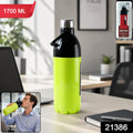 Person holding the 1700ml water bottle by its convenient carry strap for easy transport.