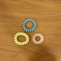 Lifestyle image of colorful spiral hair bands in use
