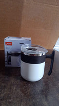 Close-up side view of the white insulated mug on a flat surface.