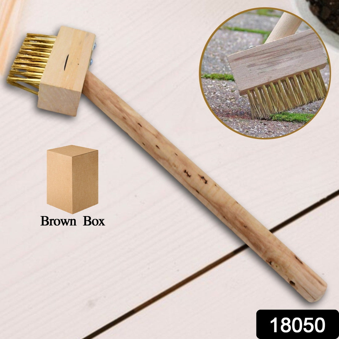 Paving Brush with wooden handle for removing weeds from patio.