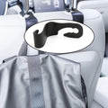 Compact car back support hanger securely attached to a car seat.