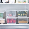 Detailed view of the removable drain plate inside the Tidy Table food container.