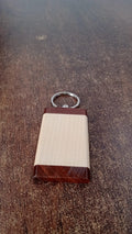 Wooden keychain placed in a lifestyle setting emphasizing natural style and functionality