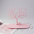 Front view of pink deer jewelry stand with earrings and rings, India