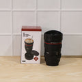 Camera lens coffee mug placed on a table with a camera, perfect for photography lovers.
