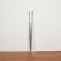 Stainless steel chopsticks actively used to pick up food during a meal.